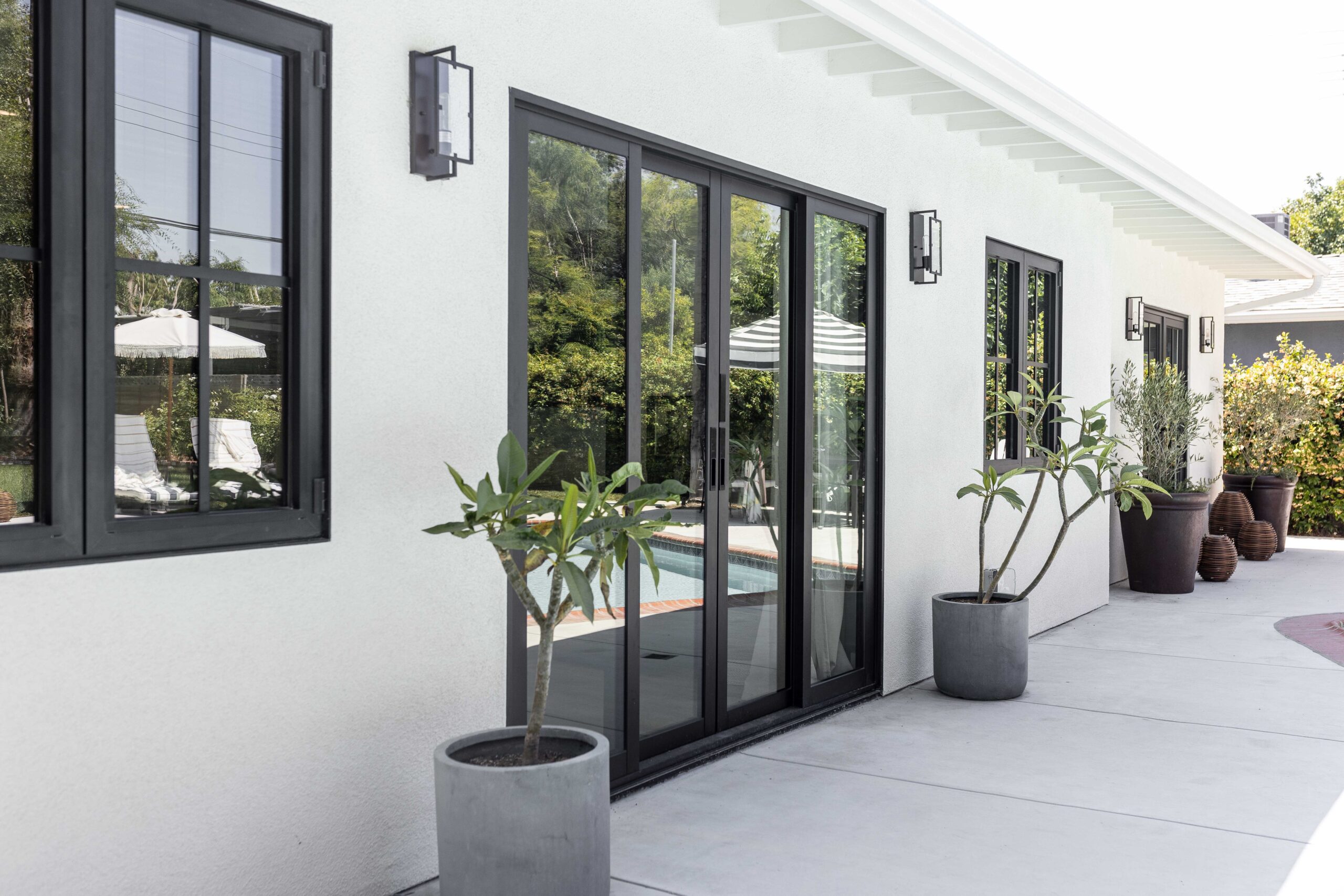 Architectural detail of a corner window configuration at Veronica Valencia's "Revealed" Home, showcasing the precise installation of the All Weather Architectural Aluminum products.